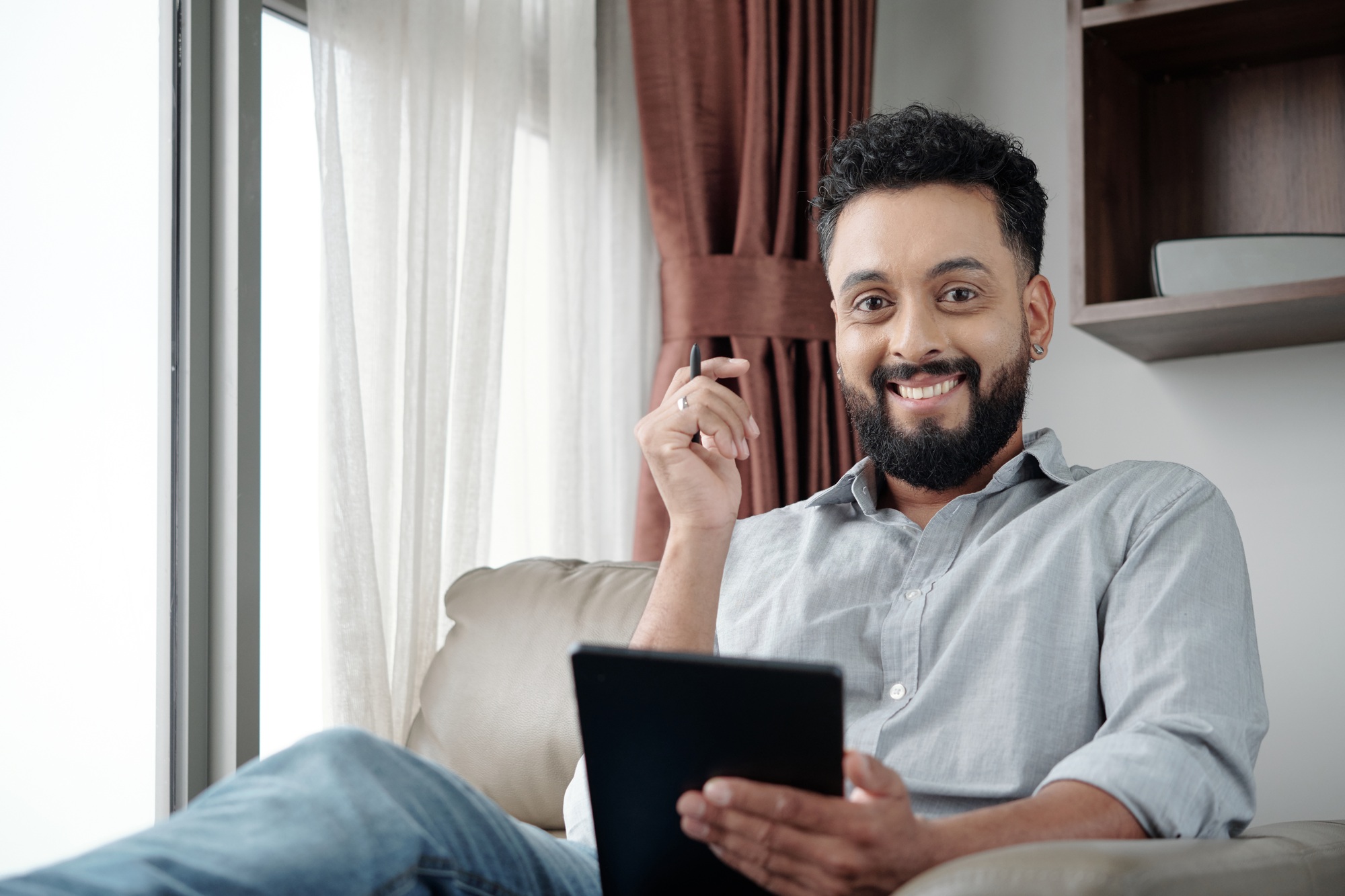 Smiling Man Drawing Sketch on Tablet
