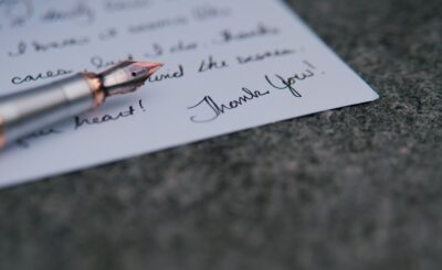 a pen on top of a piece of paper with writing on it